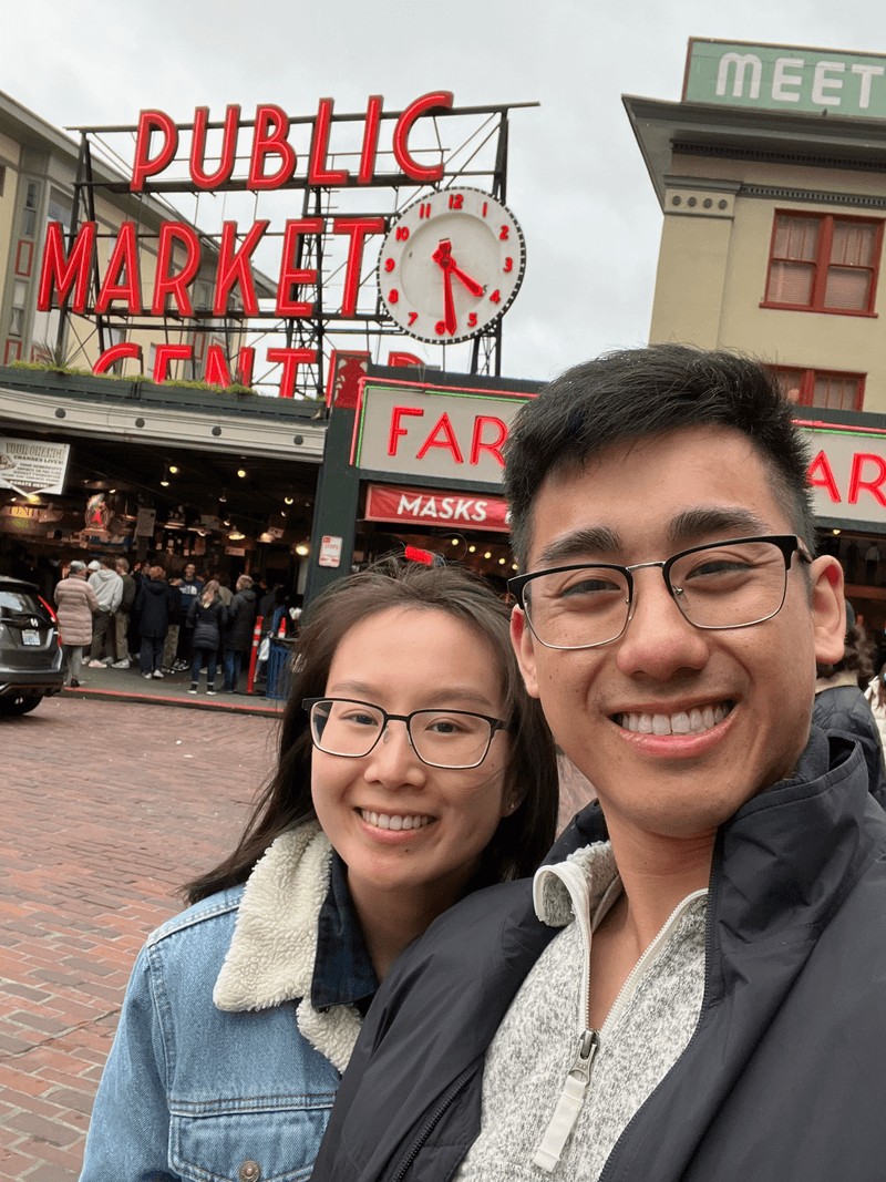 two people in front of Pike Place market